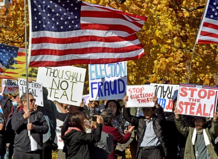 Protesters hold placards as they chant slogans during the demonstration in Wilkes-Barre on 6 November 2020.