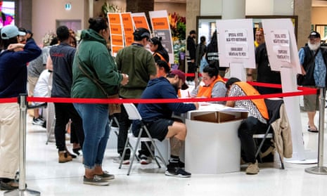 Voters queue to cast their votes in the 2023 general election at a polling station in Auckland.