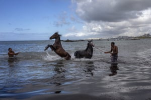 Albert Franca, right, and Ruan Gabriel wash their horses in the Atlantic Ocean, Salvador, Brazil