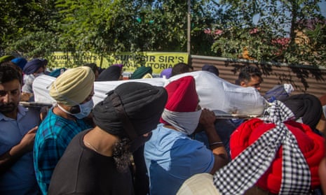 Sikh mourners carry the body of Supinder Kour, who was killed by suspected militants along with her colleague, Deepak Chand.