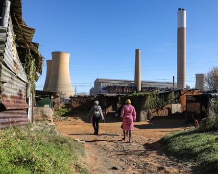 People walk past Komati power station