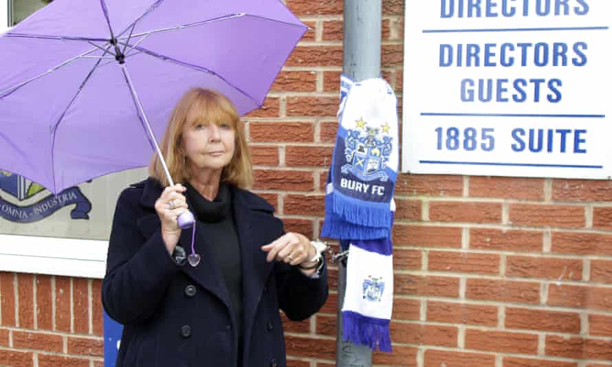 Joy Hart, former director at Bury FC, locks herself to a drainpipe near Gigg Lane in protest against the club’s owner.