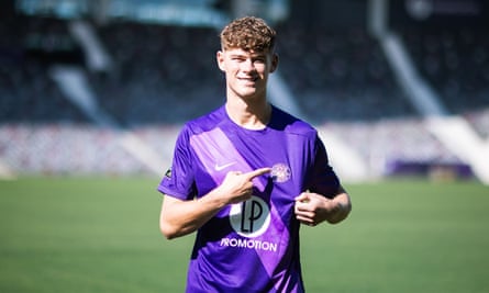 Charlie Cresswell points to the Toulouse badge on his shirt as he is unveiled as the club’s first signing of the 2024 summer transfer window.