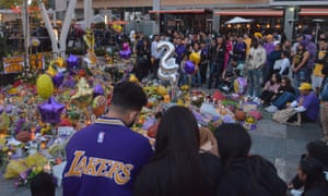 Fans gather around a memorial outside the Staples Center on Tuesday.