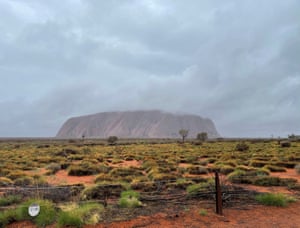Uluru shrouded by clouds