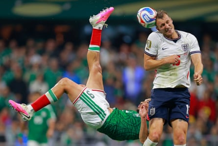 Dan Burn of England blocks a bicycle kick from Raúl Jiménez during the last-16 match in Mexico City.