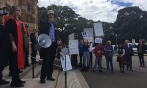 Nick Riemer addresses the protest against John Howard’s honorary doctorate outside the Great Hall at Sydney University on Friday.