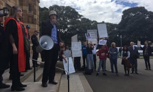 Nick Riemer addresses the protest against John Howard’s honorary doctorate outside the Great Hall at Sydney University on Friday. 