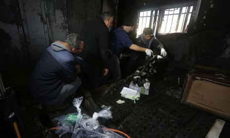 Israeli police inspect the burnt-out home of Ibrahim Dawabsha in Duma in the occupied West Bank
