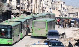 People get on buses to be evacuated from east Aleppo.