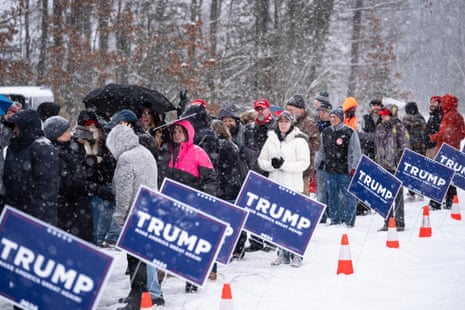 People wait to enter a Donald Trump campaign event during a winter snowstorm in Atkinson.