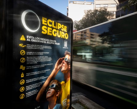 An information panel displays measures on how to safely view an upcoming solar eclipse on a street in Palma de Mallorca.