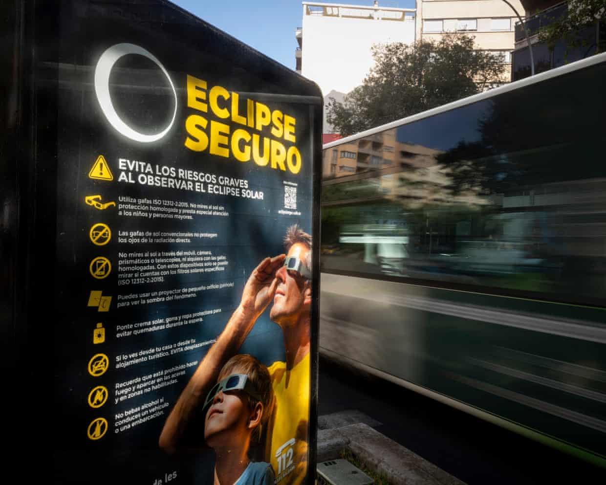 An information panel displays measures on how to safely view an upcoming solar eclipse on a street in Palma de Mallorca.