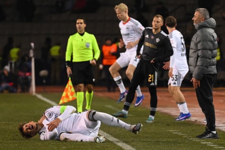Gurban Gurbanov watches on as Eintracht Frankfurt’s Robin Koch rolls on the pitch in pain in the Champions League