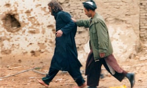 Lindh is led away after being captured among al-Qaida and Taliban prisoners in Afghanistan in December 2001.