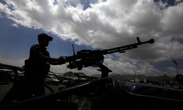 A Houthi soldier mans a machine gun on a vehicle while on patrol in Sana’a, Yemen