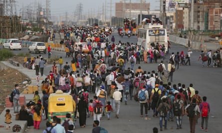 Indian migrant workers walk out of Delhi along a highway towards their villages following the announcement of lockdown, 28 March 2020.