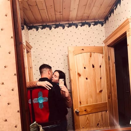 Lana Del Rey and Clayton Johnson kiss, reflected in a mirror