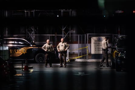 Police stand guard in the parking lot of the Maricopa county election center in Phoenix, Arizona, on 9 November 2022.