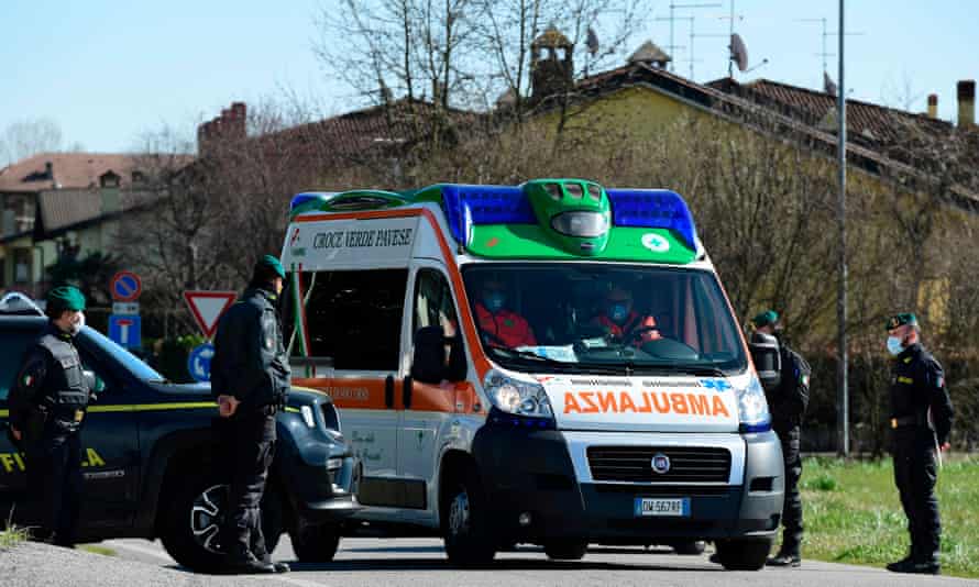 An ambulance at a check-point at one of the entrance of the small town of Zorlesco, south-east of Milan.