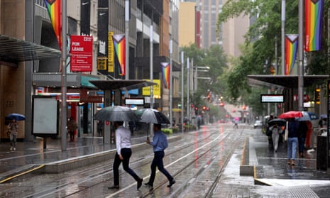 People pictured walking in the rain in the Sydney CBD