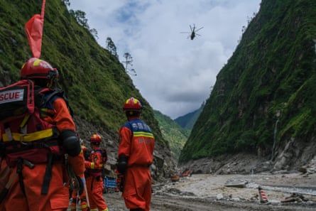 A rescue helicopter delivers supplies at the mudslide-hit area in Gyirong