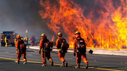 Inmate firefighters battle the Easy fire in Simi Valley, California. The state has for decades deployed thousands of incarcerated people to respond to wildfires.