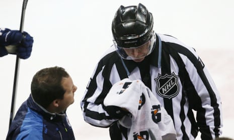 Referee Brad Kovachik is hit in the face in a game between the Winnipeg Jets and Toronto Maple Leafs earlier this month.