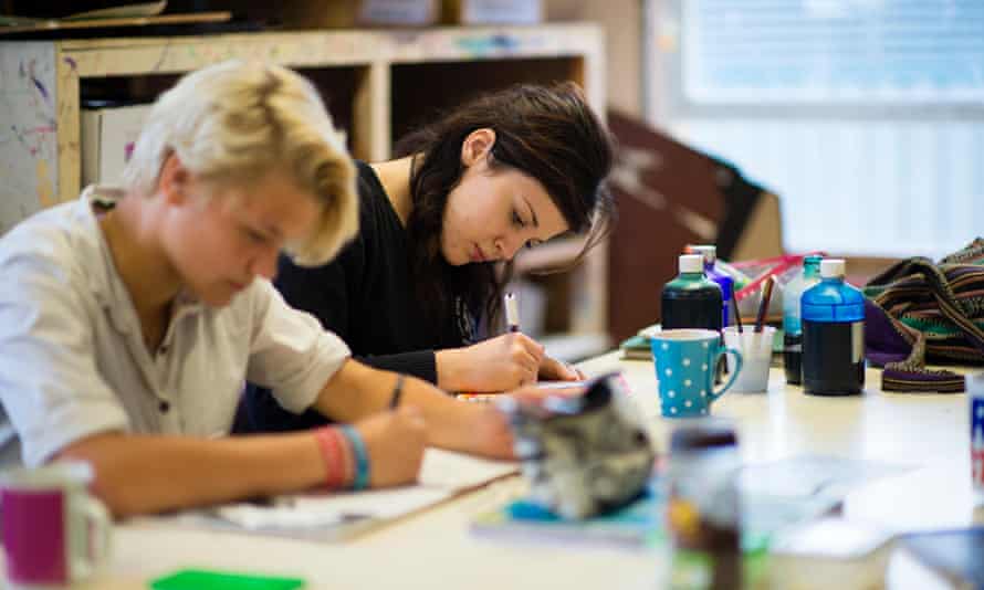 two year 12 teenage girls working in an A Level art class lesson