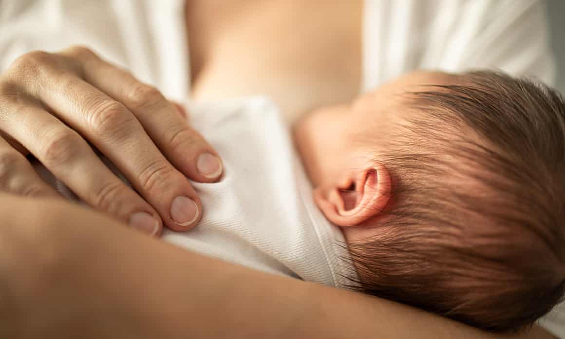 A mother breastfeeding her baby.