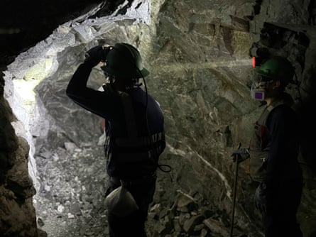 A miner silhouetted in a tunnel