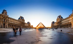 The Louvre and pyramid during sunset, in Paris, France.