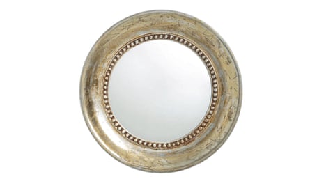 A round mirror with an aged gold frame from La Redoute