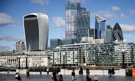 The City of London financial district can be seen as people walk along the south side of the River Thames in 2021