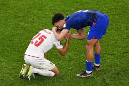 Antonee Robinson of United States consoles Abolfazl Jalali of IR Iran after the FIFA World Cup Qatar 2022 Group B match between IR Iran and USA at Al Thumama Stadium on November 29, 2022 in Doha, Qatar.