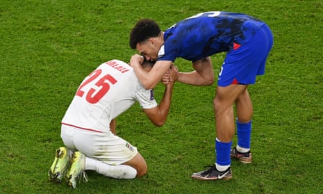 Antonee Robinson consoles Abolfazl Jalali at the end of USA’s victory over Iran at the World Cup