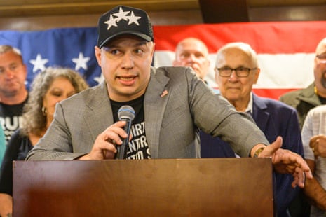 Anthony Constantino speaks into a microphone at a podium, delivering his primary victory speech