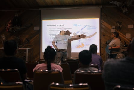 People look at a projection at an information session.