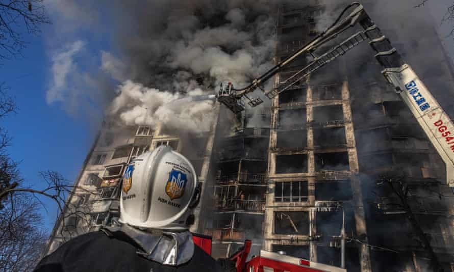 Firefighters extinguish the fire in a residential building in Kyiv that was hit by artillery shelling on Tuesday.