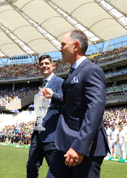 Alastair Cook and Justin Langer walk the trophy out on to the field on day one