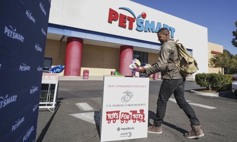  A customer donates a toy during a Toys for Tots drive outside of Petsmart in Vista, California, in November 2019.