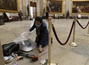 Representative Kim cleans up debris and personal belongings strewn across the floor of the Rotunda in the early morning hours of Thursday, 7 Jan 2021, after protesters stormed the Capitol.