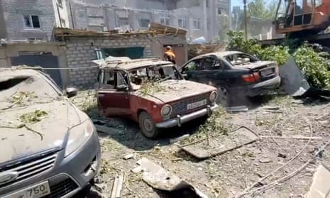 Destroyed building and cars after what local Russian-installed authorities called a Ukrainian military strike in the settlement of Yubileiny in the Luhansk region of Russian-controlled Ukraine.