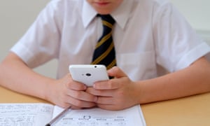 schoolboy using mobile phone