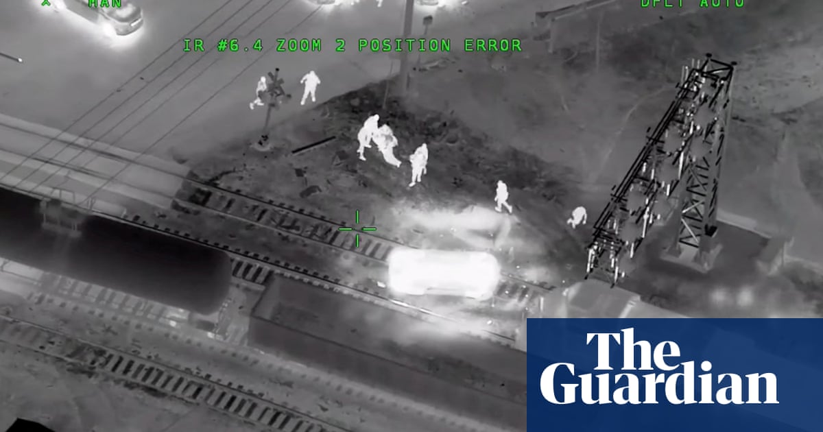 Man pulled from stolen police car in US moments before train crashes into it – video