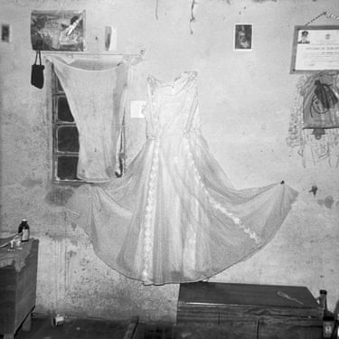My first Communion dress hanging on the wall by Dalida Reyes