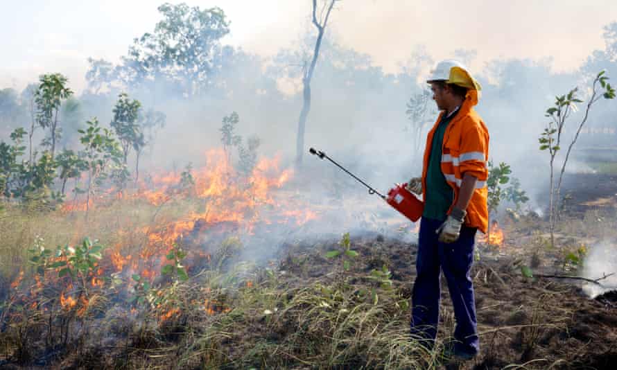 Stafford Yam uses a drip torch to create a fire break in savannah woodland at Oriners station in Cape York, Queensland on 29th June, 2016. The Oriners and Sefton Savannah Burning Project creates carbon credits, using strict scientific methodologies, approved through a rigorous accreditation process with the Department of Environment, to store carbon in the natural landscape.