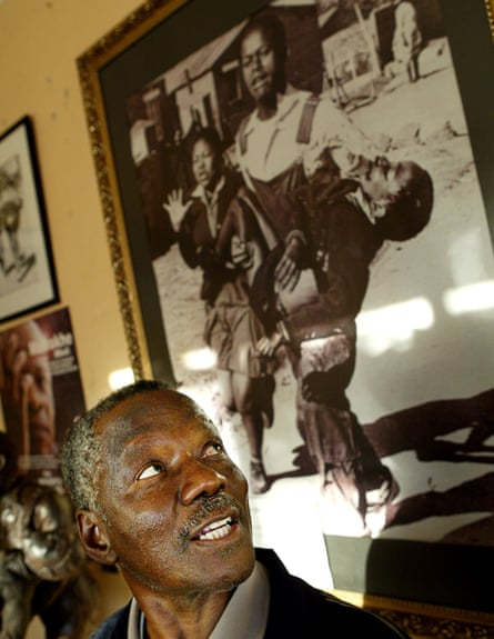 South African photojournalist Sam Nzima, with the photo he took of Hector Pieterson.