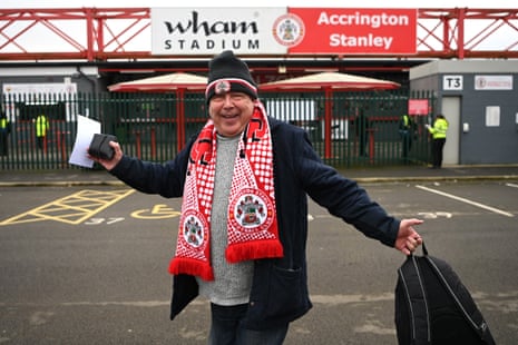 An Accrington fan poses outside the Wham Stadium.