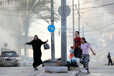 Palestinians run for cover after a strike near the al-Shifa hospital on 1 November 2023
